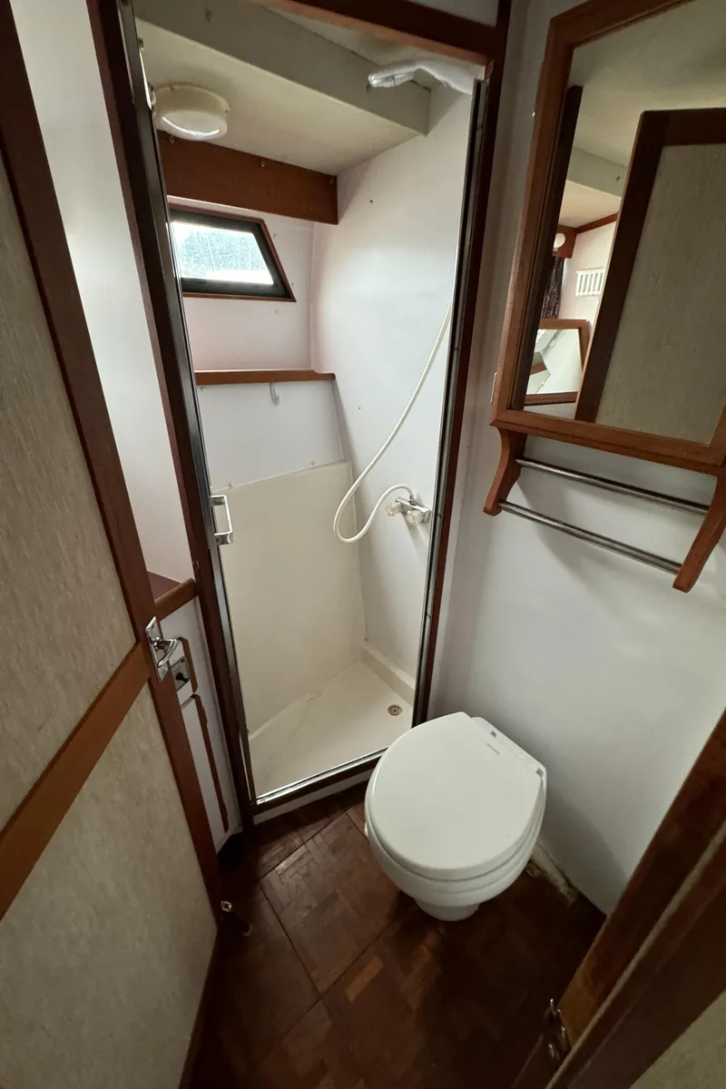 Slide: The Image of 1986 Carver Mariner 3297 bathroom with shower, toilet, and wooden accents. - 8