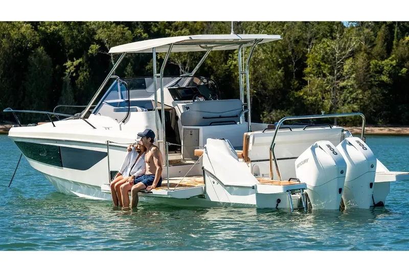 Slide: The Image of Beneteau Flyer 9 SUNdeck 2026 on calm water with two people. - 2