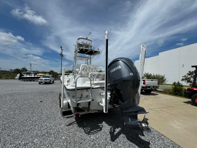 Slide: The Image of 2023 Blazer Bay 2400 boat with Yamaha engine, parked on gravel under a blue sky. - 10