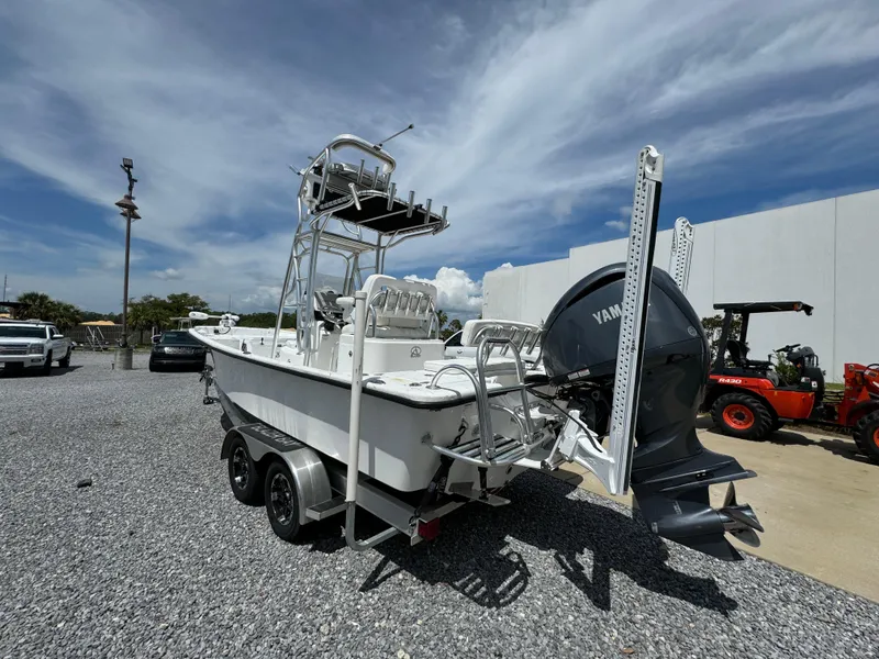 Slide: The Image of 2023 Blazer Bay 2400 boat with Yamaha engine on trailer, parked outdoors. - 11
