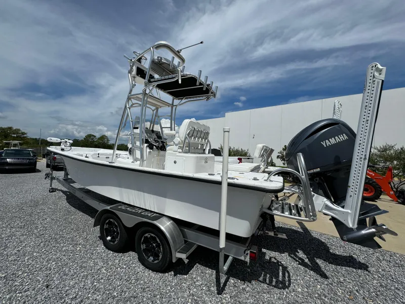 Slide: The Image of 2023 Blazer Bay 2400 boat with Yamaha engine on a trailer, parked outdoors. - 12