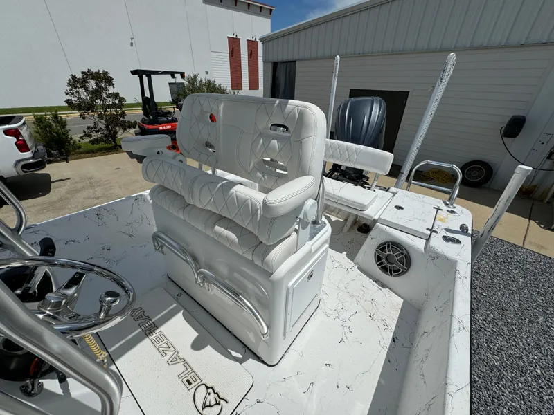 Slide: The Image of 2023 Blazer Bay 2400 boat interior with white seating and steering wheel. - 20