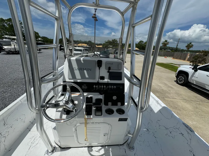 Slide: The Image of 2023 Blazer Bay 2400 boat console with Garmin navigation system, steering wheel, and controls. - 22