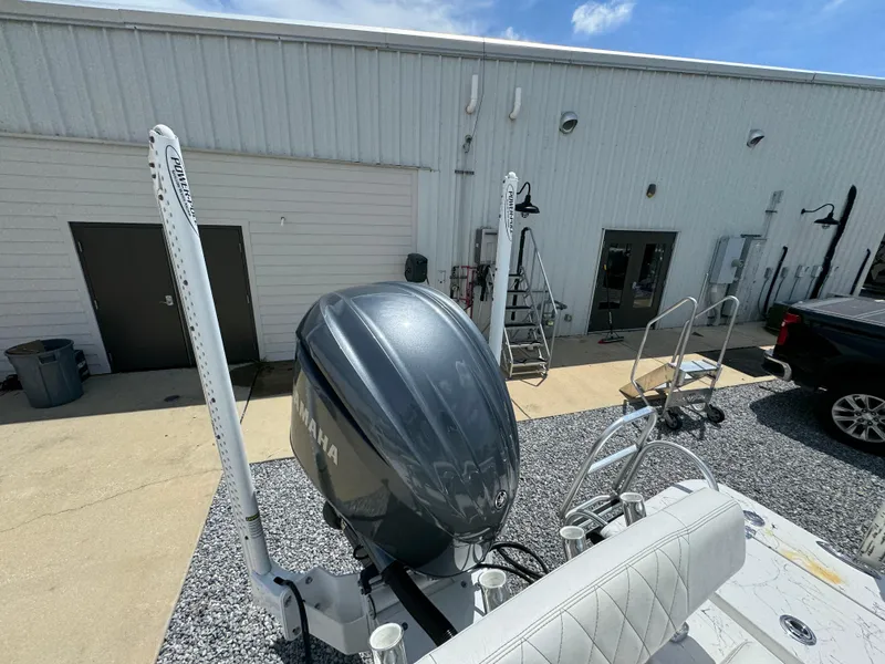 Slide: The Image of 2023 Blazer Bay 2400 boat with Yamaha outboard motor, parked near a building. - 27