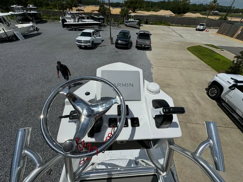 Slide: The Image of 2023 Blazer Bay 2400 boat helm with Garmin system, parked in dealership lot. - 29