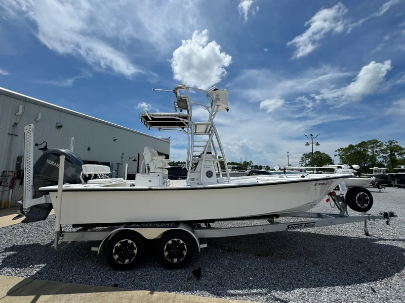 Slide: The Image of 2023 Blazer Bay 2400 boat on trailer under blue sky. - 5