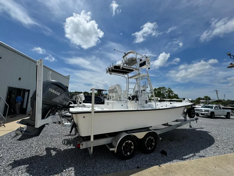Slide: The Image of 2023 Blazer Bay 2400 boat on trailer under blue sky with clouds. - 6