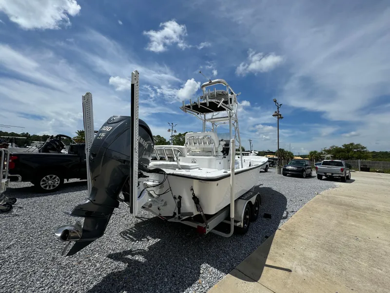 Slide: The Image of 2023 Blazer Bay 2400 boat on trailer under clear sky in parking area. - 7