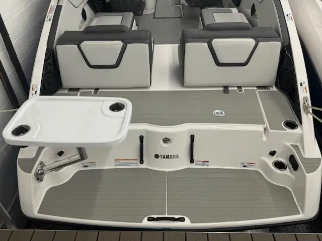 Slide: The Image of 2025 Yamaha AR250 boat interior with seating and table setup. - 18