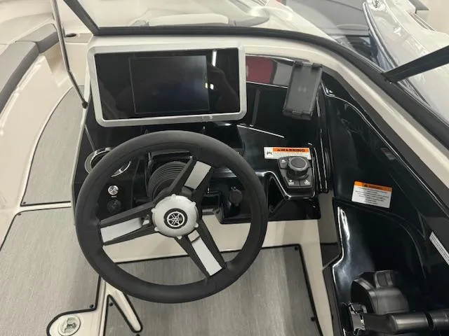 Slide: The Image of 2025 Yamaha Boats AR250 dashboard with steering wheel and touchscreen display. - 7