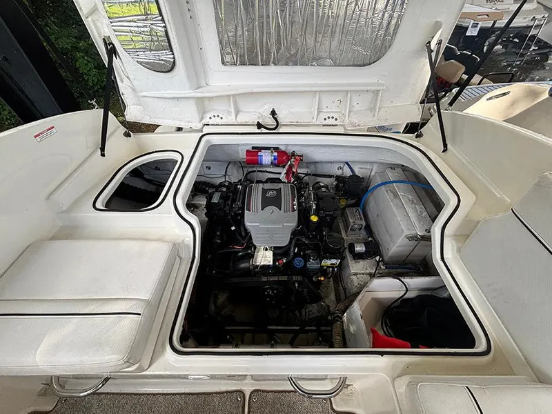 Slide: The Image of 2014 Bayliner 642 Cuddy engine compartment, showcasing clean and organized mechanical components. - 10