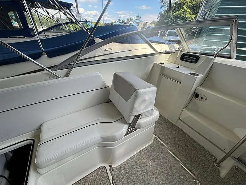 Slide: The Image of 2014 Bayliner 642 Cuddy interior with white seating and dashboard view. - 12