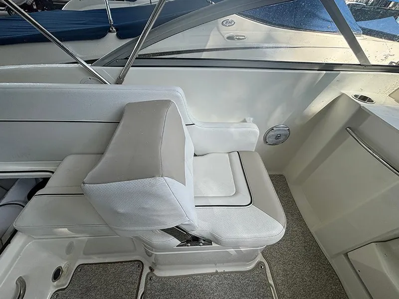 Slide: The Image of 2014 Bayliner 642 Cuddy interior seating with white upholstery and modern design. - 13