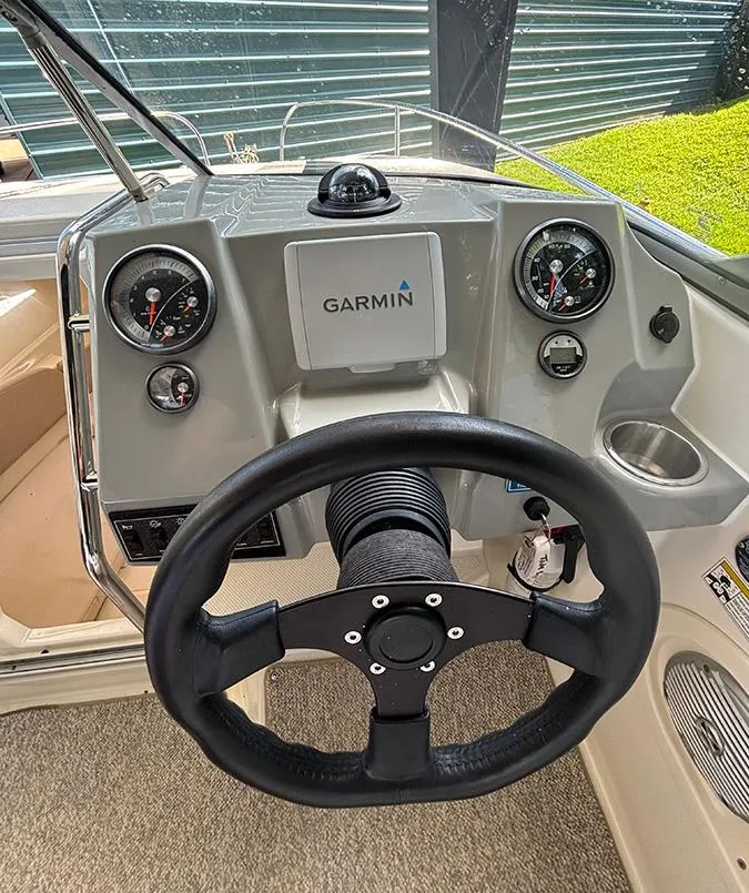 Slide: The Image of 2014 Bayliner 642 Cuddy dashboard with Garmin navigation and steering wheel. - 3