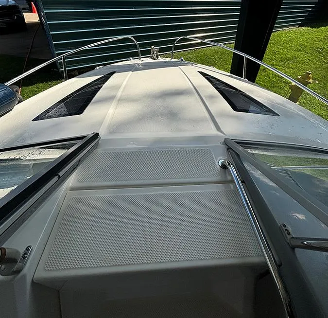 Slide: The Image of 2014 Bayliner 642 Cuddy boat deck with open hatch, viewed from above. - 4