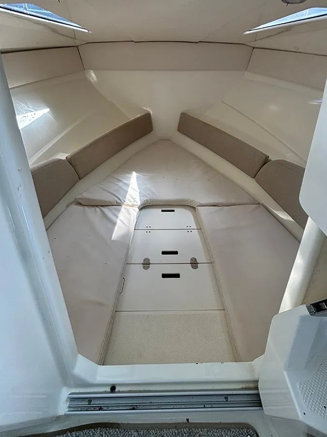 Slide: The Image of 2014 Bayliner 642 Cuddy cabin interior with beige cushions and sleek design. - 5