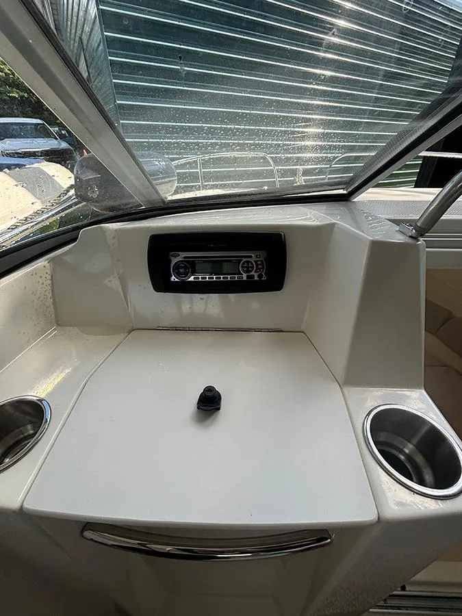 Slide: The Image of 2014 Bayliner 642 Cuddy dashboard with stereo and cup holders. - 7