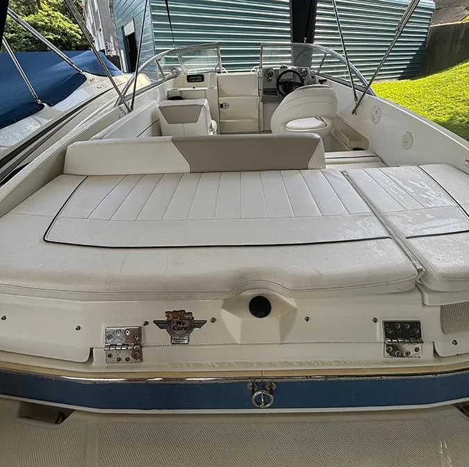 Slide: The Image of 2014 Bayliner 642 Cuddy boat interior with white seating and steering console. - 8