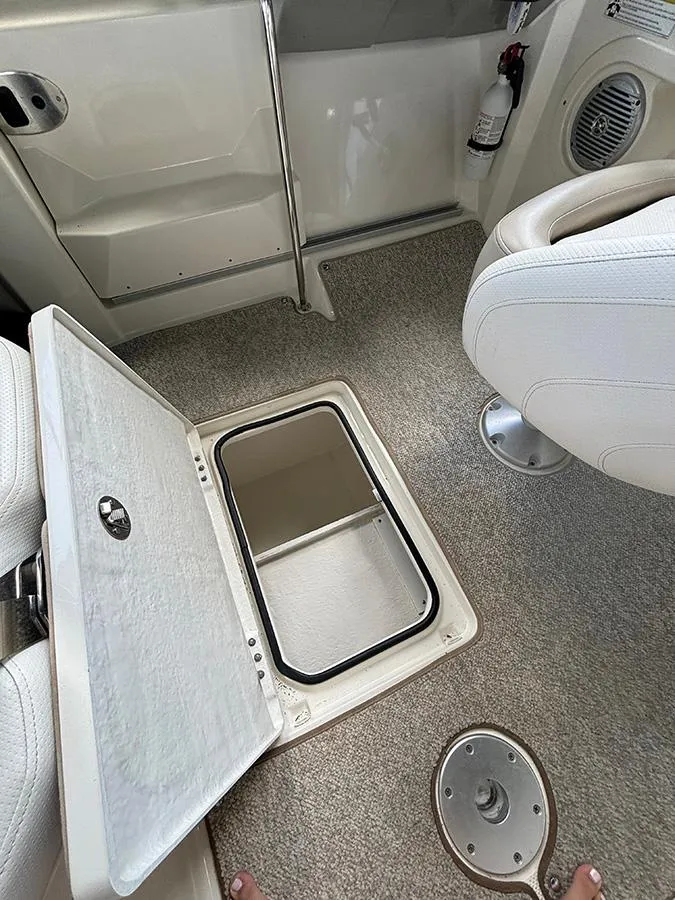 Slide: The Image of 2014 Bayliner 642 Cuddy interior with open storage compartment and seating. - 9