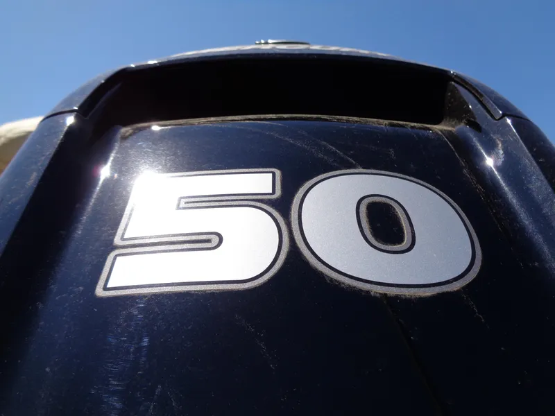 Slide: The Image of Close-up of a 50 HP outboard motor on a 2025 Sun Tracker Bass Buggy 16 XL Select. - 11