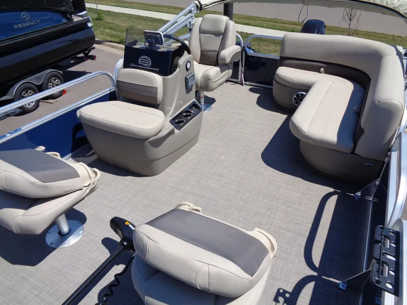 Slide: The Image of 2025 Sun Tracker Bass Buggy 16 XL Select pontoon boat interior with beige seating and steering console. - 13