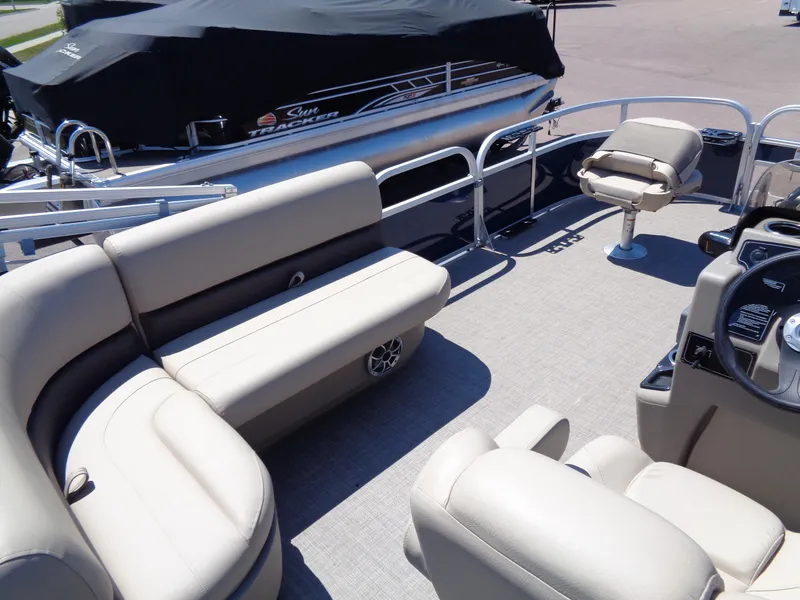 Slide: The Image of 2025 Sun Tracker Bass Buggy 16 XL Select pontoon boat interior with seating and steering console. - 14