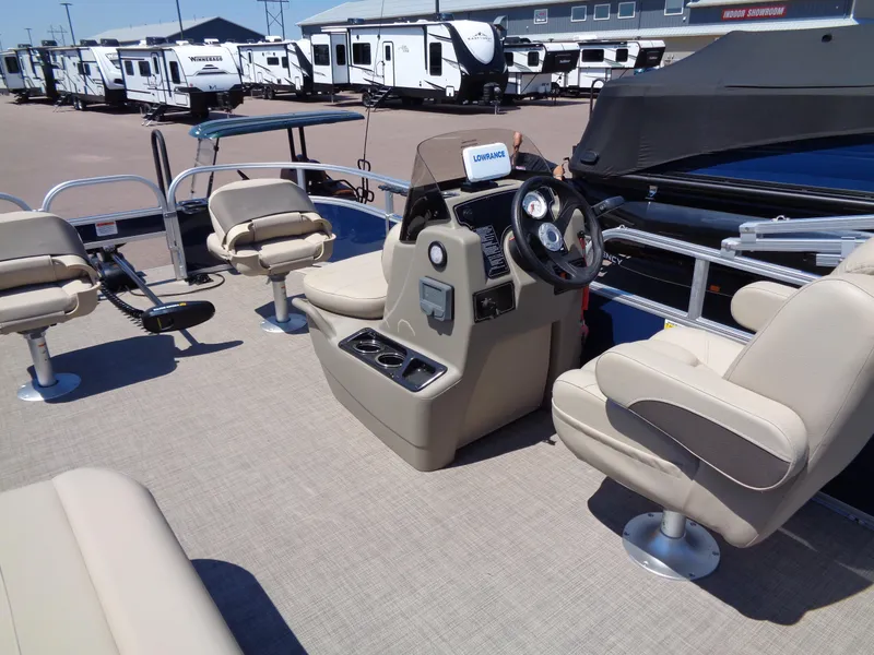 Slide: The Image of 2025 Sun Tracker Bass Buggy 16 XL Select pontoon boat interior with beige seating. - 15