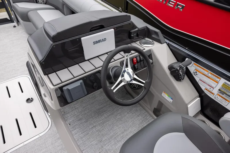 Slide: The Image of 2025 Premier 250 Solaris RF boat dashboard with steering wheel and Simrad display. - 10