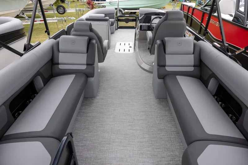 Slide: The Image of 2025 Premier 250 Solaris RF pontoon boat interior with gray seating and modern design. - 14