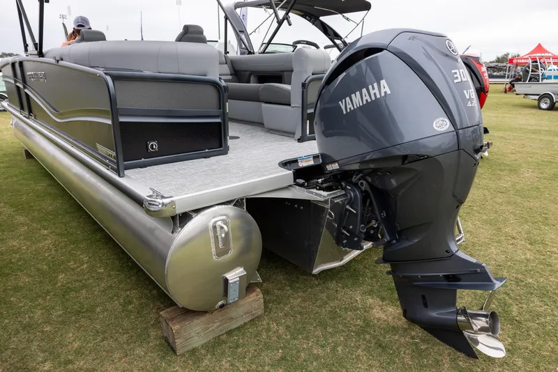 Slide: The Image of 2025 Premier 250 Solaris RF pontoon boat with Yamaha 300 V6 engine on grass. - 3