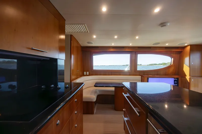 Slide: The Image of Luxurious interior of 2005 Hatteras 54 Convertible yacht with modern kitchen and seating area. - 14