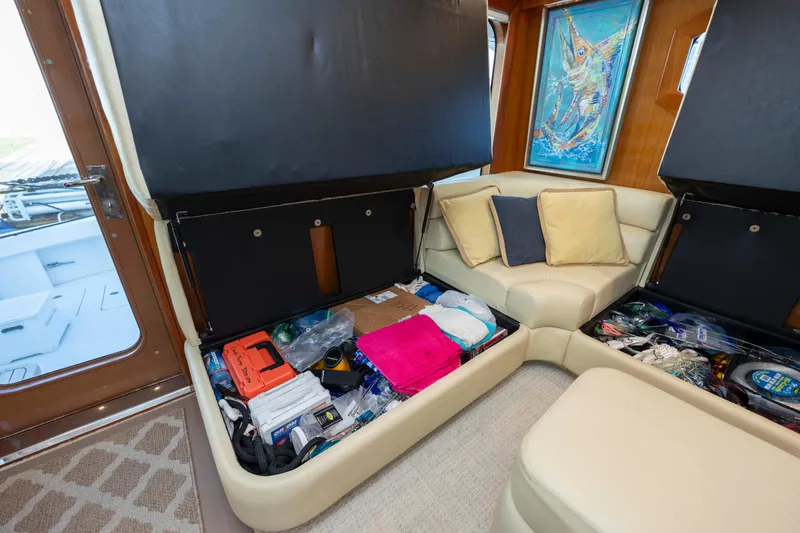 Slide: The Image of Interior of 2005 Hatteras 54 Convertible yacht with under-seat storage and colorful cushions. - 17