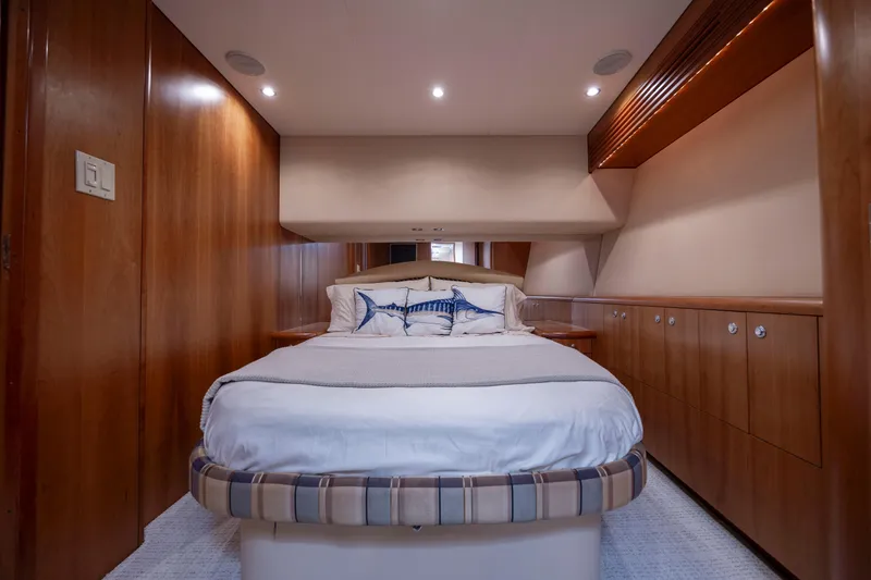 Slide: The Image of Luxurious cabin interior of 2005 Hatteras 54 Convertible yacht with cozy bed and wooden finishes. - 24