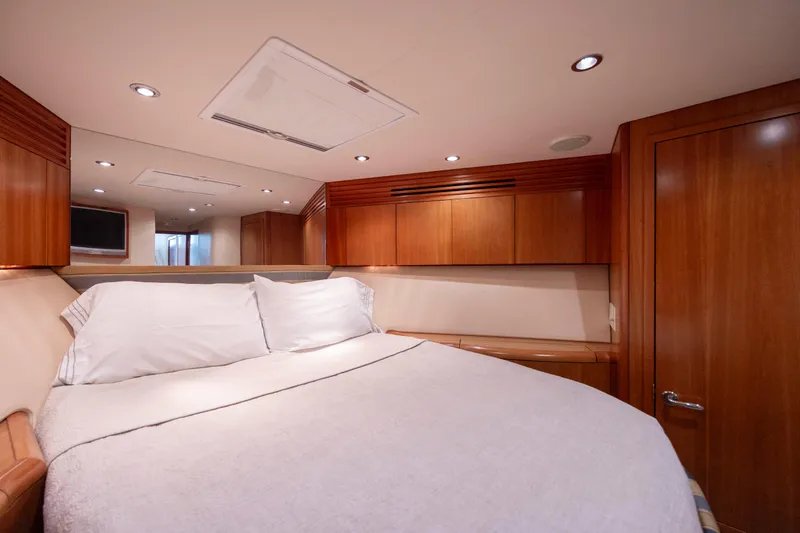 Slide: The Image of Luxurious bedroom interior of 2005 Hatteras 54 Convertible yacht with wood paneling. - 33
