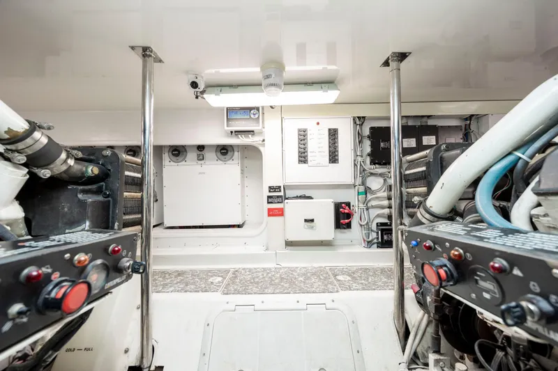 Slide: The Image of Engine room of 2005 Hatteras 54 Convertible yacht, showcasing control panels and equipment. - 36