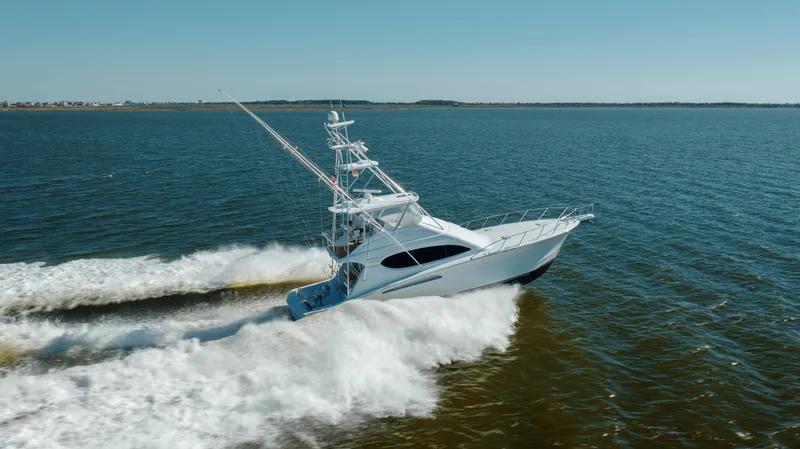 Slide: The Image of 2005 Hatteras 54 Convertible yacht cruising on open water. - 4
