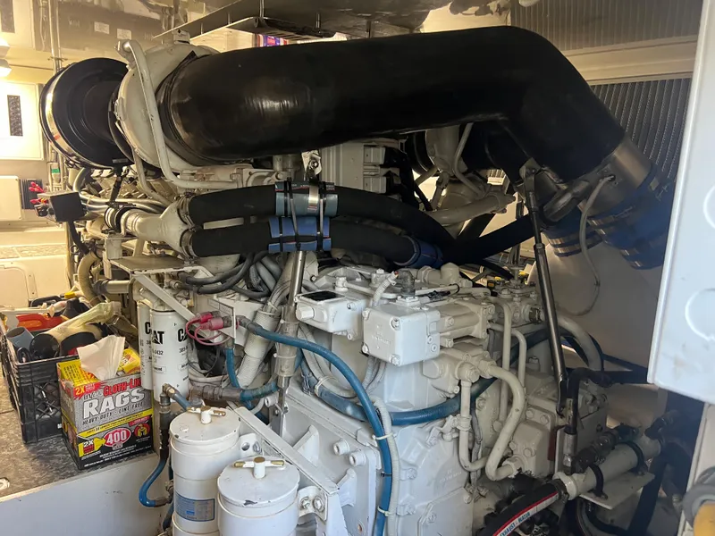 Slide: The Image of Engine room of 2005 Hatteras 54 Convertible yacht, showcasing complex machinery and components. - 40