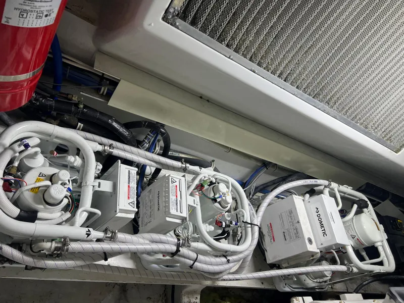 Slide: The Image of Engine room of 2005 Hatteras 54 Convertible with mechanical components and fire extinguisher. - 41