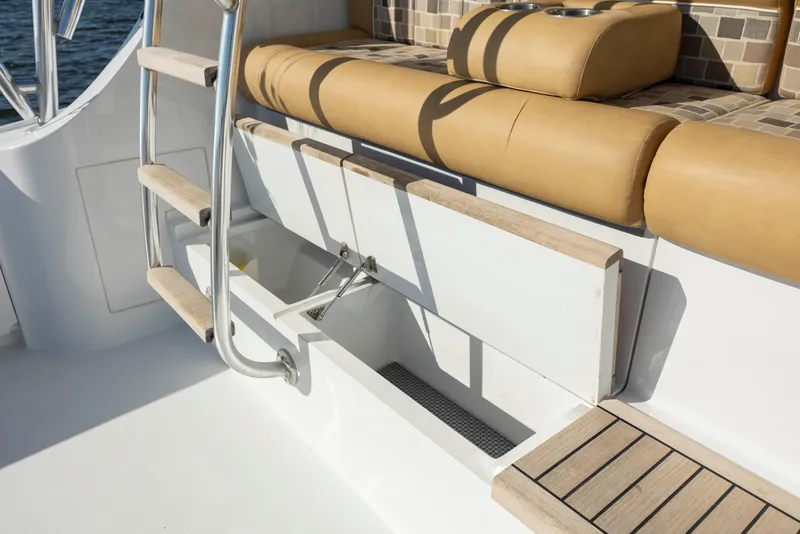 Slide: The Image of Hatteras 54 Convertible 2005 yacht seating area with storage and ladder. - 6