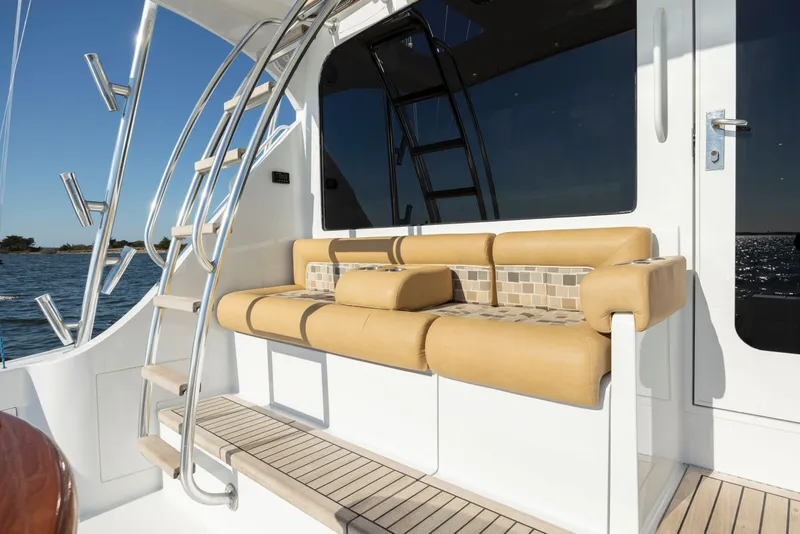 Slide: The Image of 2005 Hatteras 54 Convertible yacht with beige seating and sleek design. - 7