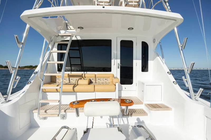 Slide: The Image of 2005 Hatteras 54 Convertible yacht deck with seating and ladder. - 8