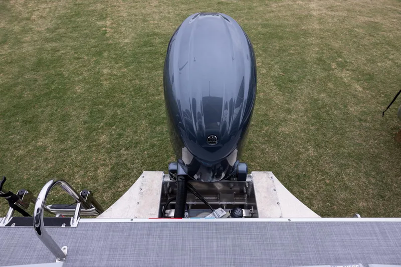 Slide: The Image of Premier 220 Sunscape RF 2025 boat engine on grass, rear view with ladder. - 14