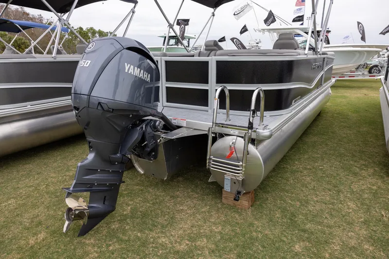 Slide: The Image of 2025 Premier 220 Sunscape RF pontoon boat with Yamaha outboard motor displayed on grass. - 2