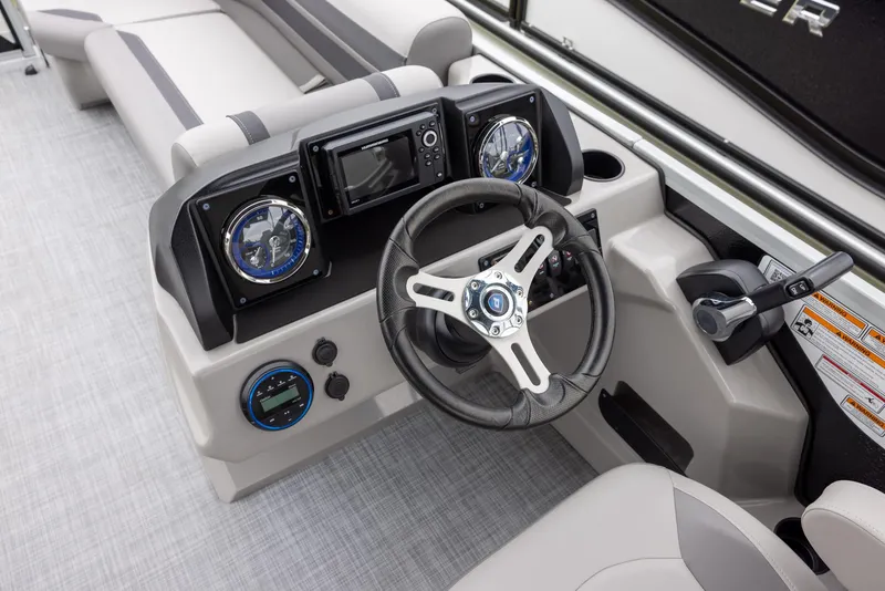 Slide: The Image of 2025 Premier 220 Sunscape RF boat dashboard with steering wheel and gauges. - 9