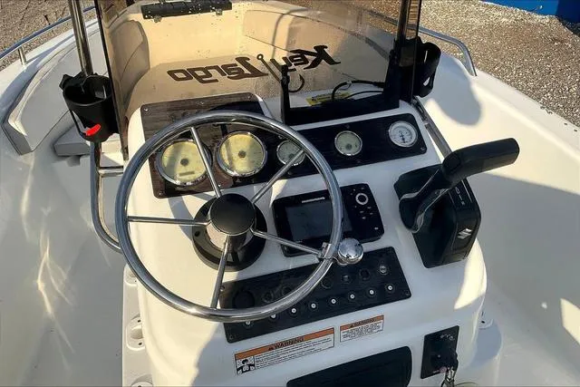 Slide: The Image of 2021 Key Largo 1800 CC boat dashboard with steering wheel and controls. - 11
