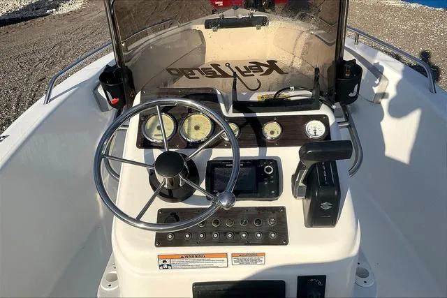Slide: The Image of 2021 Key Largo 1800 CC boat dashboard with steering wheel and controls. - 12