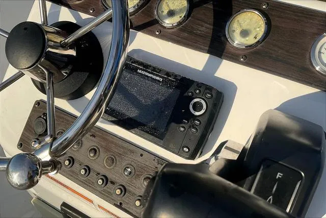 Slide: The Image of Control panel of 2021 Key Largo 1800 CC boat with steering wheel and gauges. - 16
