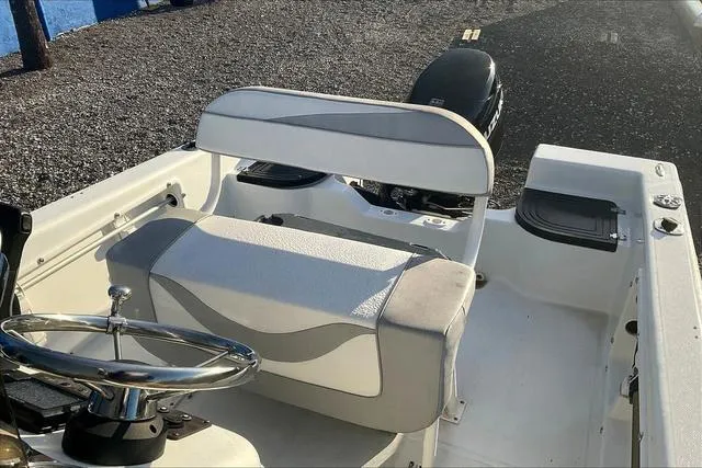 Slide: The Image of 2021 Key Largo 1800 CC boat interior with steering wheel and seating. - 18