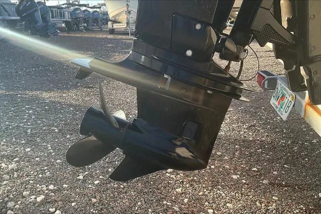 Slide: The Image of Outboard motor of a 2021 Key Largo 1800 CC boat on gravel surface. - 24