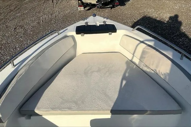 Slide: The Image of 2021 Key Largo 1800 CC boat interior with cushioned seating and storage. - 26